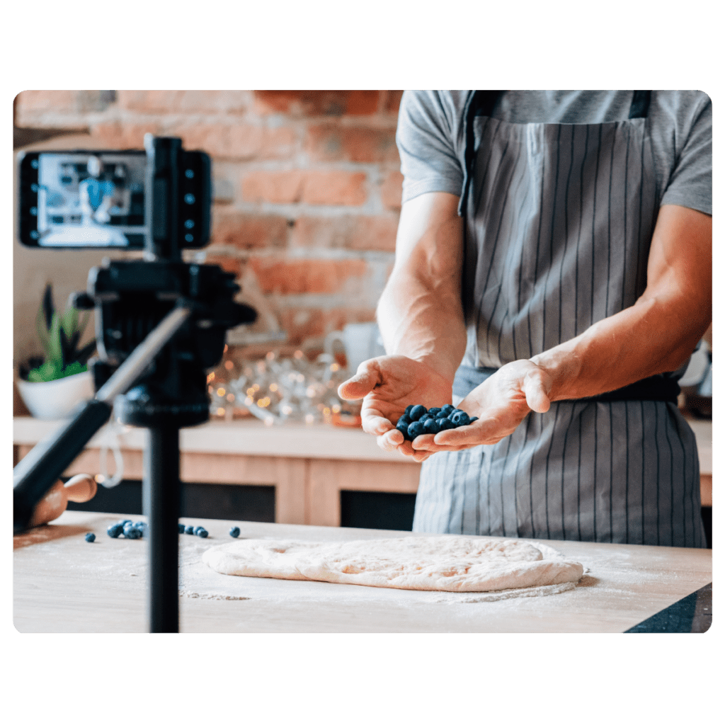 A male cooking social media influencer is creating a video for YouTube.